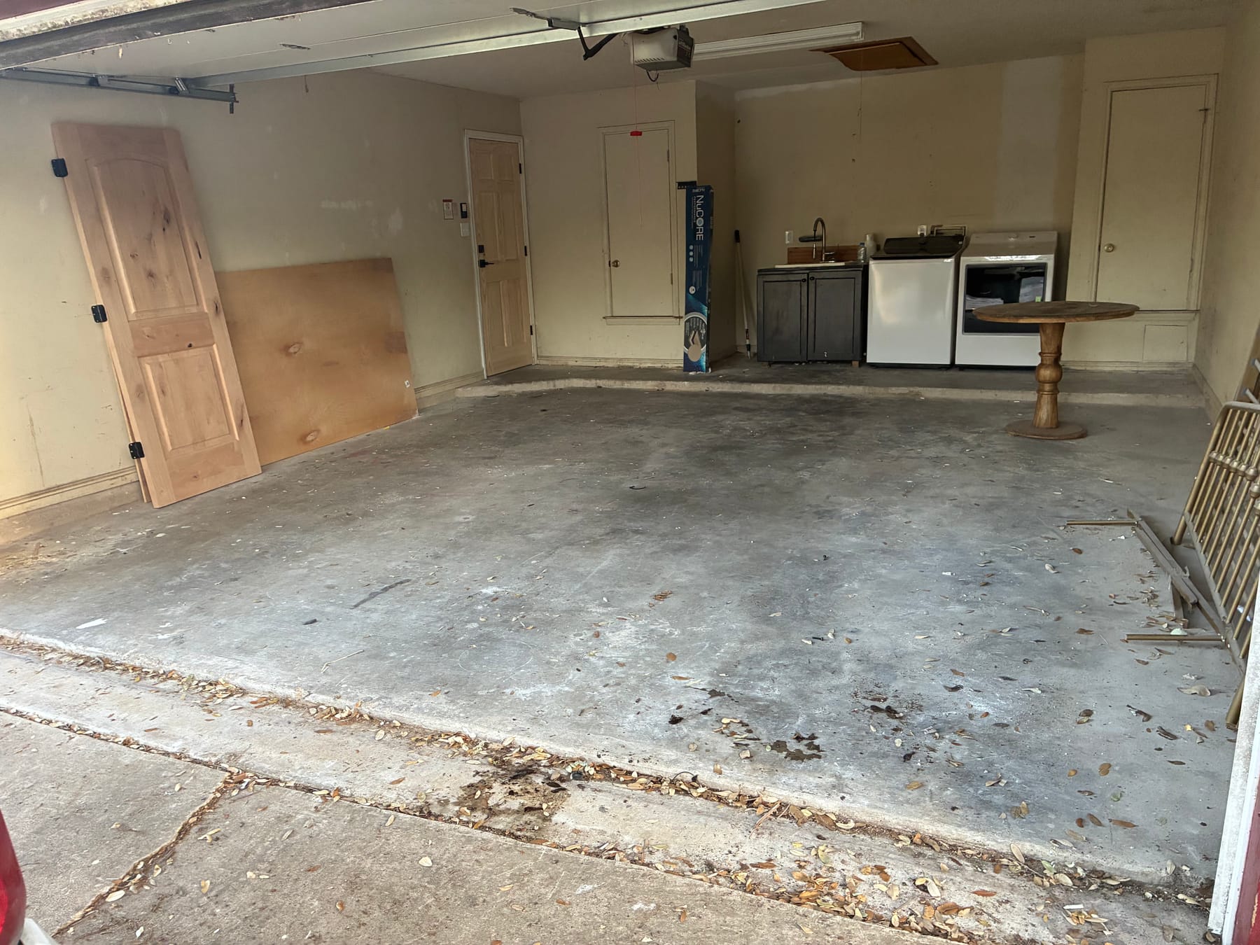 A residential garage cleared and swept after a cleanout