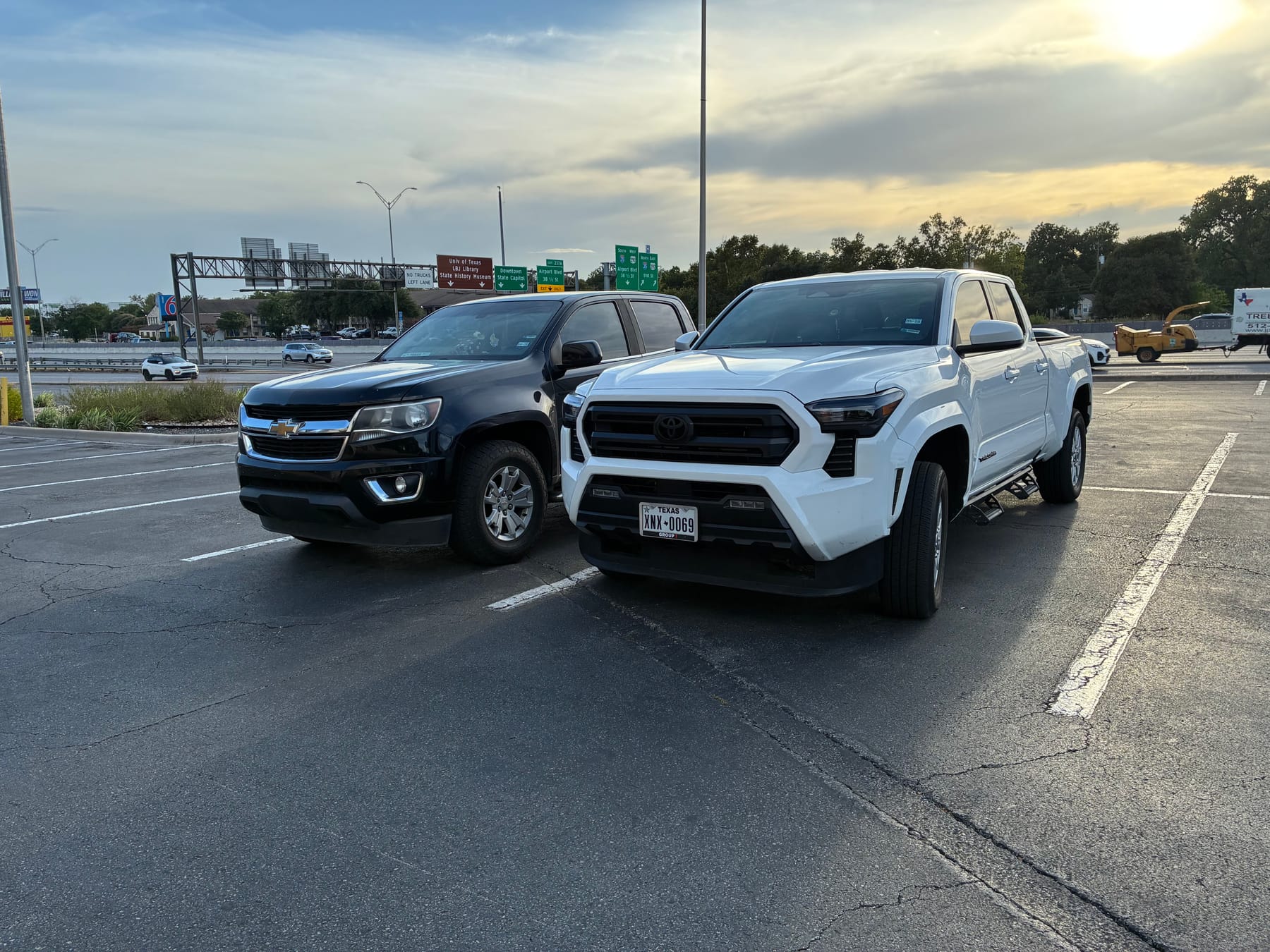 The company pickup trucks parked in an Austin lot at sunset